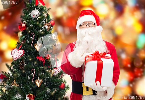 Image of man in costume of santa claus with gift box