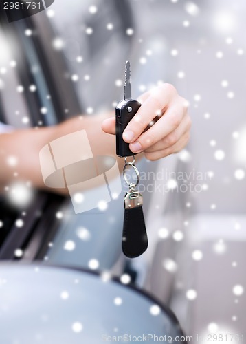 Image of close up of man with car key outdoors