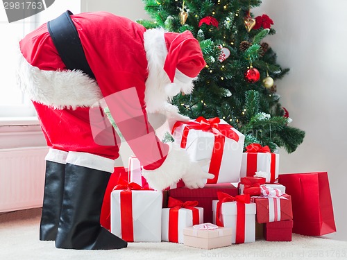 Image of man in costume of santa claus with presents