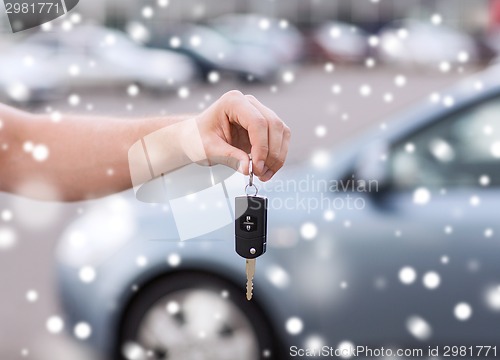 Image of close up of man with car key outdoors