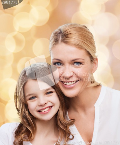 Image of smiling mother and little girl