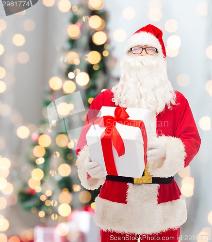 Image of man in costume of santa claus with gift box