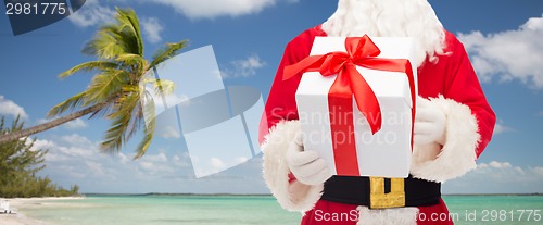 Image of man in costume of santa claus with gift box