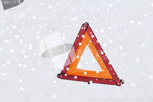 Image of closeup of warning triangle on snow