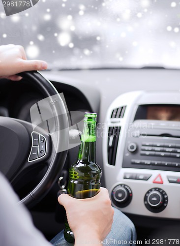 Image of close up of man drinking alcohol while driving car