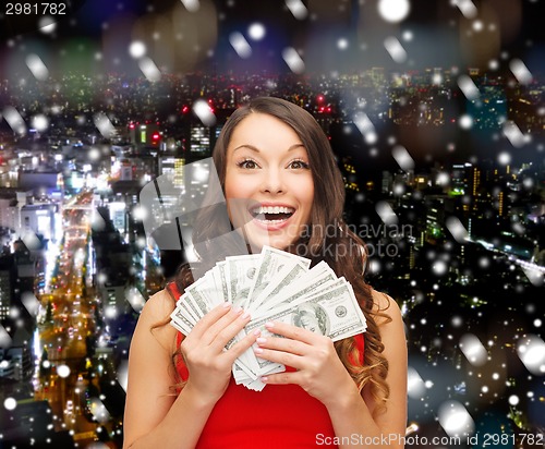 Image of woman in red dress with us dollar money