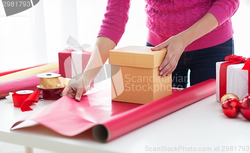 Image of close up of woman decorating christmas presents