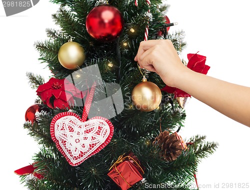 Image of close up of woman with christmas tree decoration