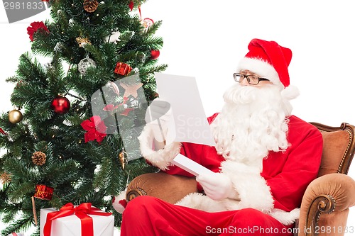 Image of man in costume of santa claus with letter