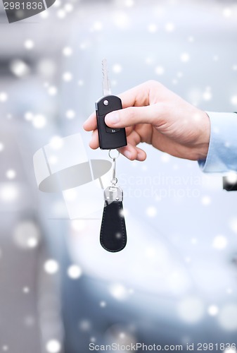 Image of close up of man with car key outdoors