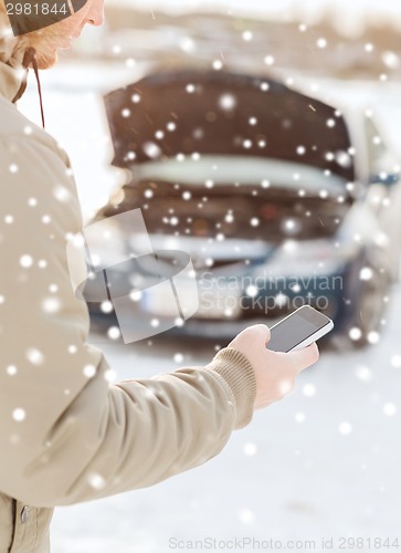 Image of closeup of man with broken car and smartphone