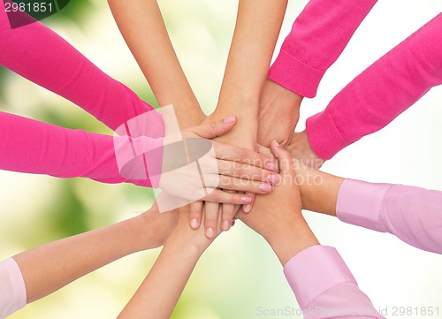 Image of close up of women with hands on top