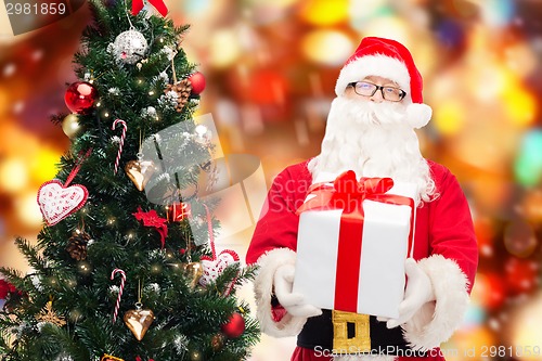 Image of man in costume of santa claus with gift box