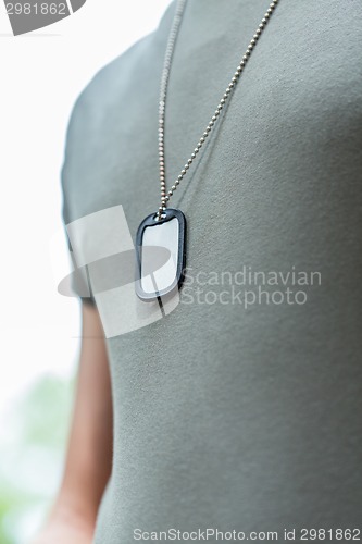 Image of close up of young soldier in military uniform