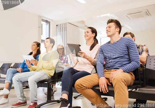 Image of group of smiling students with tablet pc