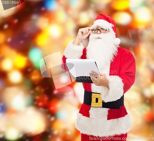 Image of man in costume of santa claus with notepad