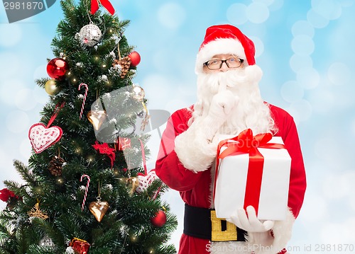 Image of man in costume of santa claus with gift box