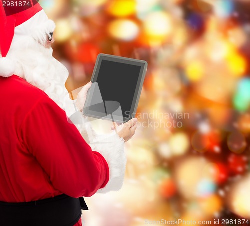 Image of man in costume of santa claus with tablet pc