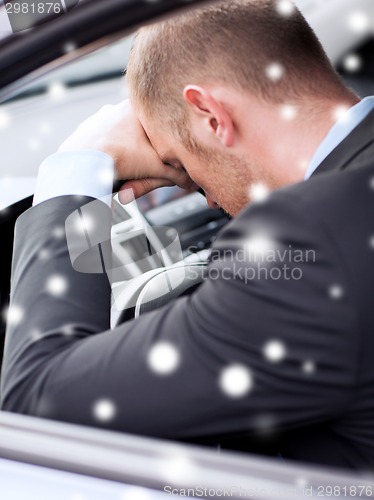 Image of close up of businessman driving car