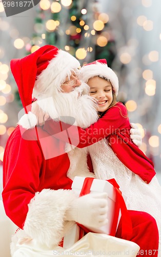 Image of smiling little girl with santa claus