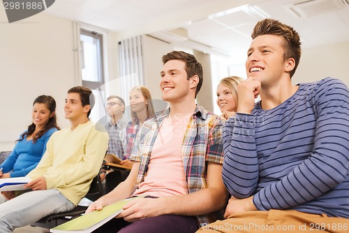 Image of group of smiling students in lecture hall