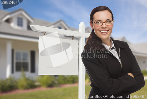 Image of Woman In Front Of House and Blank Real Estate Sign