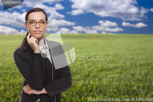 Image of Confident Woman in Grass Field Looking At Camera