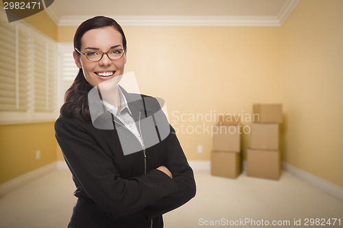 Image of Mixed Race Woman in Empty Room with Boxes