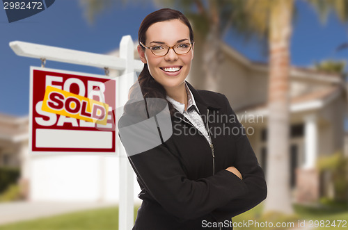 Image of Mixed Race Woman in Front of House and Sold Sign