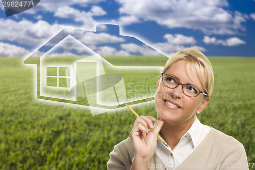 Image of Woman and Grass Field with Ghosted House Figure Behind