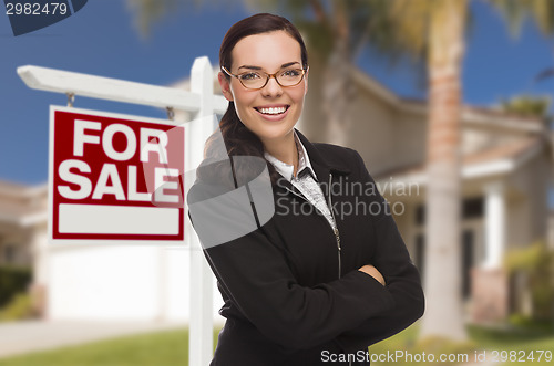 Image of Young Woman in Front of House and Sale Sign