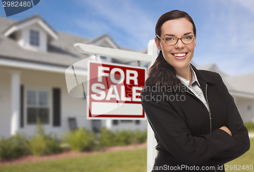 Image of Young Woman in Front of House and Sale Sign