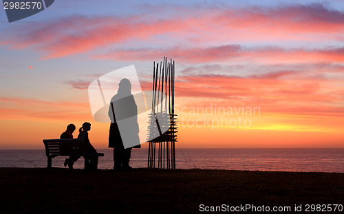 Image of Two sculptures two spectators, sunrise Sculpture by the Sea