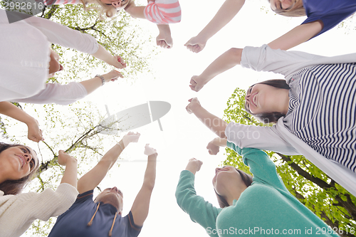 Image of young friends staying together outdoor in the park