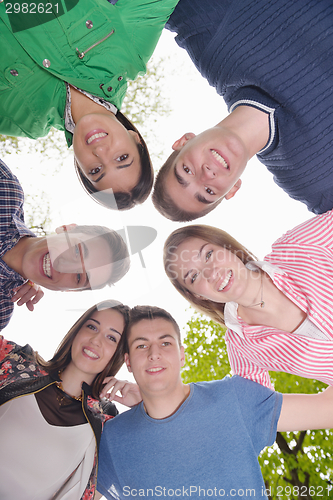 Image of young friends staying together outdoor in the park
