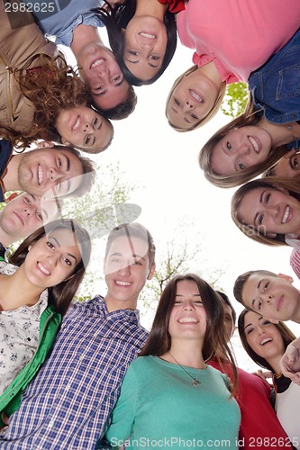 Image of young friends staying together outdoor in the park