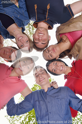 Image of young friends staying together outdoor in the park