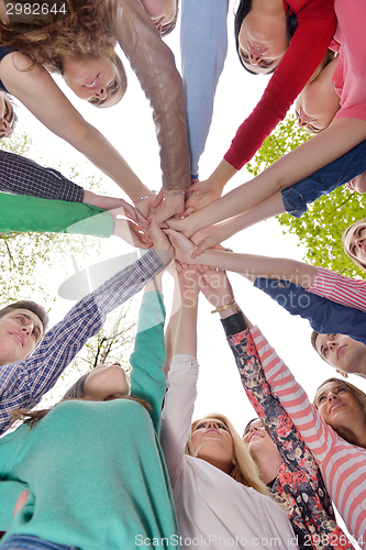 Image of young friends staying together outdoor in the park