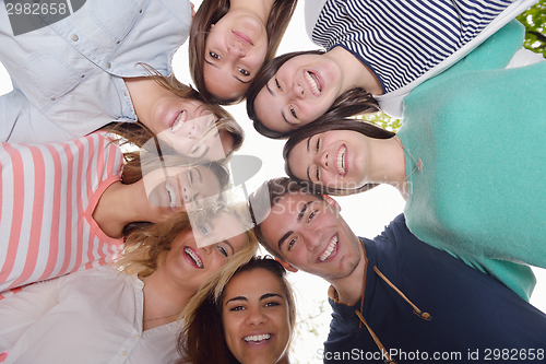 Image of young friends staying together outdoor in the park