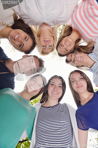 Image of young friends staying together outdoor in the park