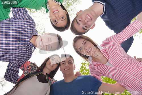 Image of young friends staying together outdoor in the park