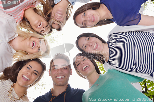 Image of young friends staying together outdoor in the park