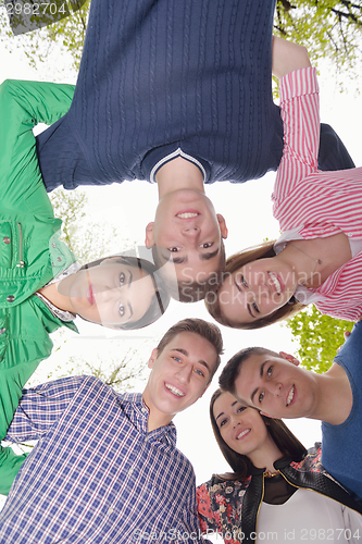 Image of young friends staying together outdoor in the park