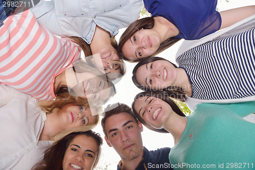Image of young friends staying together outdoor in the park