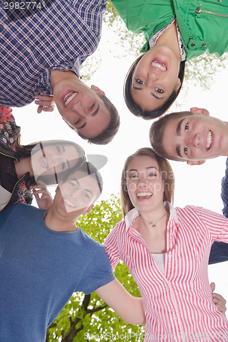 Image of young friends staying together outdoor in the park