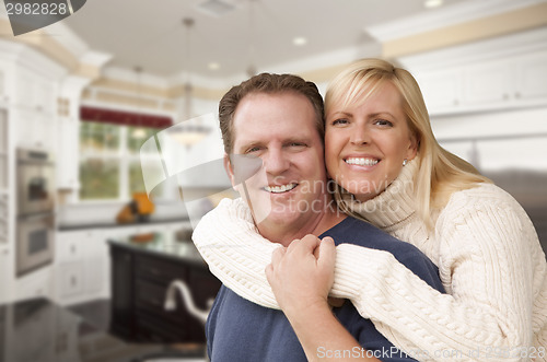 Image of Happy Couple Inside Beautiful Custom Kitchen