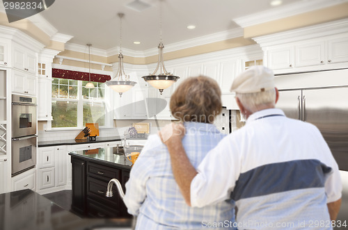 Image of Senior Couple Looking Over Beautiful Custom Kitchen