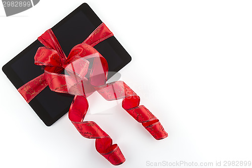 Image of tablet pc with christmas red ribbon