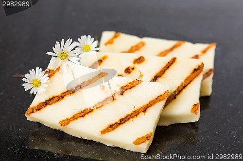 Image of Halloumi cheese frying in grill pan.