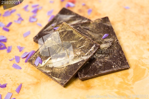 Image of dark chocolate on a wooden table.